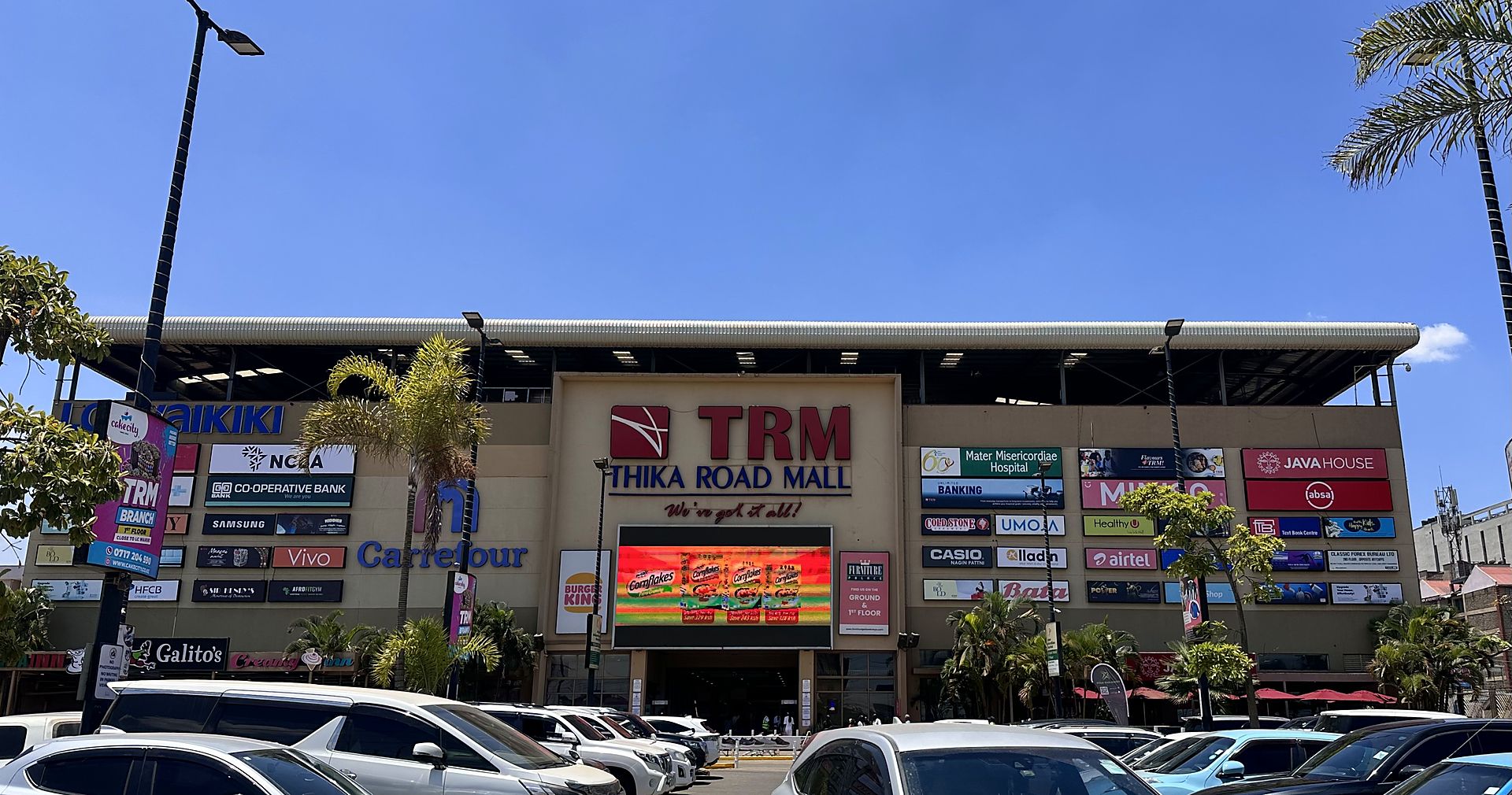 The front of Thika Road Mall: the TRM sign above the main entrance, with tenant signs across the building
